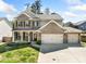 Charming two-story home featuring a brick and siding exterior, attached three-car garage, and well-manicured lawn at 3875 Grandview Manor Dr, Cumming, GA 30028