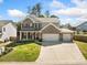 Charming two-story brick home with a three-car garage, manicured lawn and great curb appeal at 3875 Grandview Manor Dr, Cumming, GA 30028