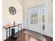 Inviting foyer with dark hardwood floors, a decorative table, and a modern white door with sidelights at 3875 Grandview Manor Dr, Cumming, GA 30028