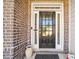 Close up of a front door with decorative brick and glass inserts, offering a welcoming entry to the home at 3875 Grandview Manor Dr, Cumming, GA 30028