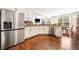 Bright kitchen with stainless steel refrigerator, white cabinets, and an open view to the dining area at 3875 Grandview Manor Dr, Cumming, GA 30028