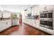 Modern kitchen features white cabinets, stainless steel appliances, and granite countertops at 3875 Grandview Manor Dr, Cumming, GA 30028