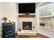 Inviting living room with stone fireplace, wood mantel, and mounted TV, perfect for cozy evenings at 3875 Grandview Manor Dr, Cumming, GA 30028