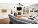 Inviting living room featuring hardwood floors, a stone fireplace, and a large window at 3875 Grandview Manor Dr, Cumming, GA 30028