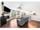 Spacious living room featuring hardwood floors, a stone fireplace, and open access to the kitchen at 3875 Grandview Manor Dr, Cumming, GA 30028