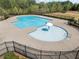 Community pool featuring a splash pad area and a surrounding fence for safety and privacy at 3875 Grandview Manor Dr, Cumming, GA 30028