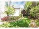 Scenic backyard with mature trees, vibrant flower beds, and a lush green lawn at 4266 Paces Ferry Road Se, Atlanta, GA 30339
