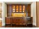 Elegant wet bar features custom cabinets, granite countertop, and wine fridge at 4266 Paces Ferry Road Se, Atlanta, GA 30339