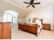 Cozy bedroom with a wooden bed, white walls, wood furniture, and arched windows at 4266 Paces Ferry Road Se, Atlanta, GA 30339