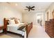 Bedroom with a ceiling fan, hardwood furniture, carpet, and an ensuite bathroom at 4266 Paces Ferry Road Se, Atlanta, GA 30339