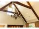 Vaulted ceiling with exposed beams and chandelier at 4266 Paces Ferry Road Se, Atlanta, GA 30339