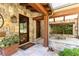 View of the stone covered patio with wood beams and stone fireplace at 4266 Paces Ferry Road Se, Atlanta, GA 30339