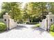 View of the Paces Oaks neighborhood entrance showing brick driveway through a double gate at 4266 Paces Ferry Road Se, Atlanta, GA 30339