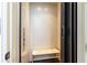 Residential elevator equipped with a bench and user-friendly control panel for accessibility at 4266 Paces Ferry Road Se, Atlanta, GA 30339