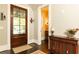 Inviting entryway with wood door, sidelight, and traditional console table at 4266 Paces Ferry Road Se, Atlanta, GA 30339