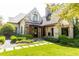 View of stone house with covered patio, fireplace and manicured landscaping at 4266 Paces Ferry Road Se, Atlanta, GA 30339