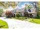 View of stone house with manicured landscaping and brick paver driveway at 4266 Paces Ferry Road Se, Atlanta, GA 30339