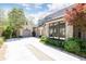 View of the three-car garage with stone facade and manicured landscape at 4266 Paces Ferry Road Se, Atlanta, GA 30339