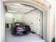 A clean garage with epoxy floors and a nice car inside at 4266 Paces Ferry Road Se, Atlanta, GA 30339