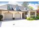 View of the detached three-car garage with stone facade and manicured landscape at 4266 Paces Ferry Road Se, Atlanta, GA 30339