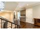 Elegant hallway showcasing dark wood floors, a staircase, and custom built-in cabinetry at 4266 Paces Ferry Road Se, Atlanta, GA 30339
