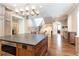 Spacious kitchen featuring dark wood floors, a center island, and a stunning chandelier at 4266 Paces Ferry Road Se, Atlanta, GA 30339