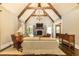 Vaulted living room features a stone fireplace, exposed beams, and elegant decor at 4266 Paces Ferry Road Se, Atlanta, GA 30339
