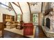 Comfortable living room showcasing stone fireplace, custom built-ins, and exposed beams at 4266 Paces Ferry Road Se, Atlanta, GA 30339