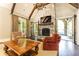 Bright living room featuring a stone fireplace, exposed beams, and french doors at 4266 Paces Ferry Road Se, Atlanta, GA 30339