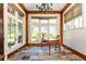 Sunlit office with hardwood trim, stone floors, and large windows offering serene outdoor views at 4266 Paces Ferry Road Se, Atlanta, GA 30339