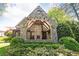 An outdoor stone fireplace and patio with dark wood ceiling beams and a stone surround at 4266 Paces Ferry Road Se, Atlanta, GA 30339