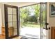 Inviting view of a patio with well-manicured greenery and a charming outdoor space, seen through glass panel doors at 4266 Paces Ferry Road Se, Atlanta, GA 30339