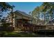 Rear exterior of a home with a multi-tiered wooden deck at 7522 Greens Mill Dr, Loganville, GA 30052