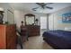 Bedroom featuring a dark wood dresser and a decorative mirror at 7522 Greens Mill Dr, Loganville, GA 30052