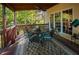 Covered patio features a ceiling fan and shade from large trees at 7522 Greens Mill Dr, Loganville, GA 30052