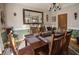 Inviting dining room featuring a dark wood table, seating for six, and an elegant mirror, perfect for Gathering meals at 7522 Greens Mill Dr, Loganville, GA 30052