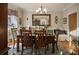 Elegant dining room with a large wooden table, seating for six, and stylish decor, ideal for formal gatherings at 7522 Greens Mill Dr, Loganville, GA 30052