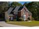 Lovely brick home with attached garage, manicured lawn, and mature trees, showcasing a comfortable suburban lifestyle at 7522 Greens Mill Dr, Loganville, GA 30052