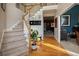 Home entry foyer with staircase and hardwood floors at 7522 Greens Mill Dr, Loganville, GA 30052