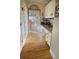 Hallway features hardwood floors, built-in desk space, and access to a sunlit dining area at 7522 Greens Mill Dr, Loganville, GA 30052