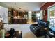Open concept living area featuring kitchen with breakfast bar and a comfortable leather recliner at 7522 Greens Mill Dr, Loganville, GA 30052