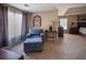 Comfortable sitting area within the main bedroom with armchair, ottoman, and bedside tables at 7522 Greens Mill Dr, Loganville, GA 30052
