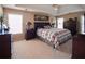 Spacious main bedroom featuring tray ceilings, ample natural light, and coordinating furniture at 7522 Greens Mill Dr, Loganville, GA 30052