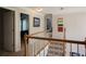 Carpeted staircase leading to the upper level, showcasing multiple bedrooms and an artwork display at 7522 Greens Mill Dr, Loganville, GA 30052