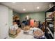 Unfinished basement storage room with shelving and tile floor at 7522 Greens Mill Dr, Loganville, GA 30052