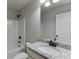 Bathroom with granite countertop, bronze fixtures, shower, and white cabinets at 110 Legion Dr, Buford, GA 30518