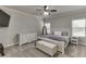 Neutral bedroom with white wood bed, fan, dresser, carpet, and plenty of natural light at 110 Legion Dr, Buford, GA 30518