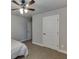 Bedroom featuring neutral tones, a ceiling fan, and two doors at 110 Legion Dr, Buford, GA 30518