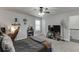 Cozy bedroom with carpet, ceiling fan, entertainment center and desk area, perfect for relaxation and entertainment at 110 Legion Dr, Buford, GA 30518