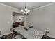 Dining room with a stylish light fixture and a view into the living room and kitchen at 110 Legion Dr, Buford, GA 30518